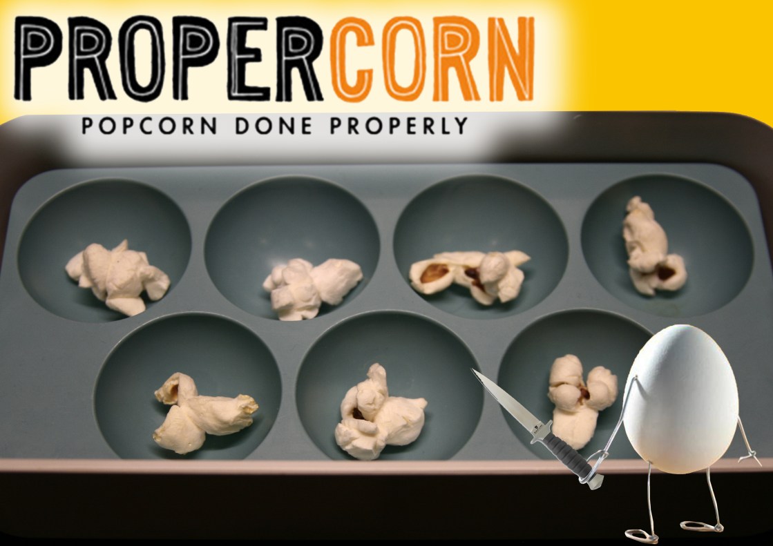 propercorn food envy advert. popcorn is in egg tray and egg is outside and holding a dagger