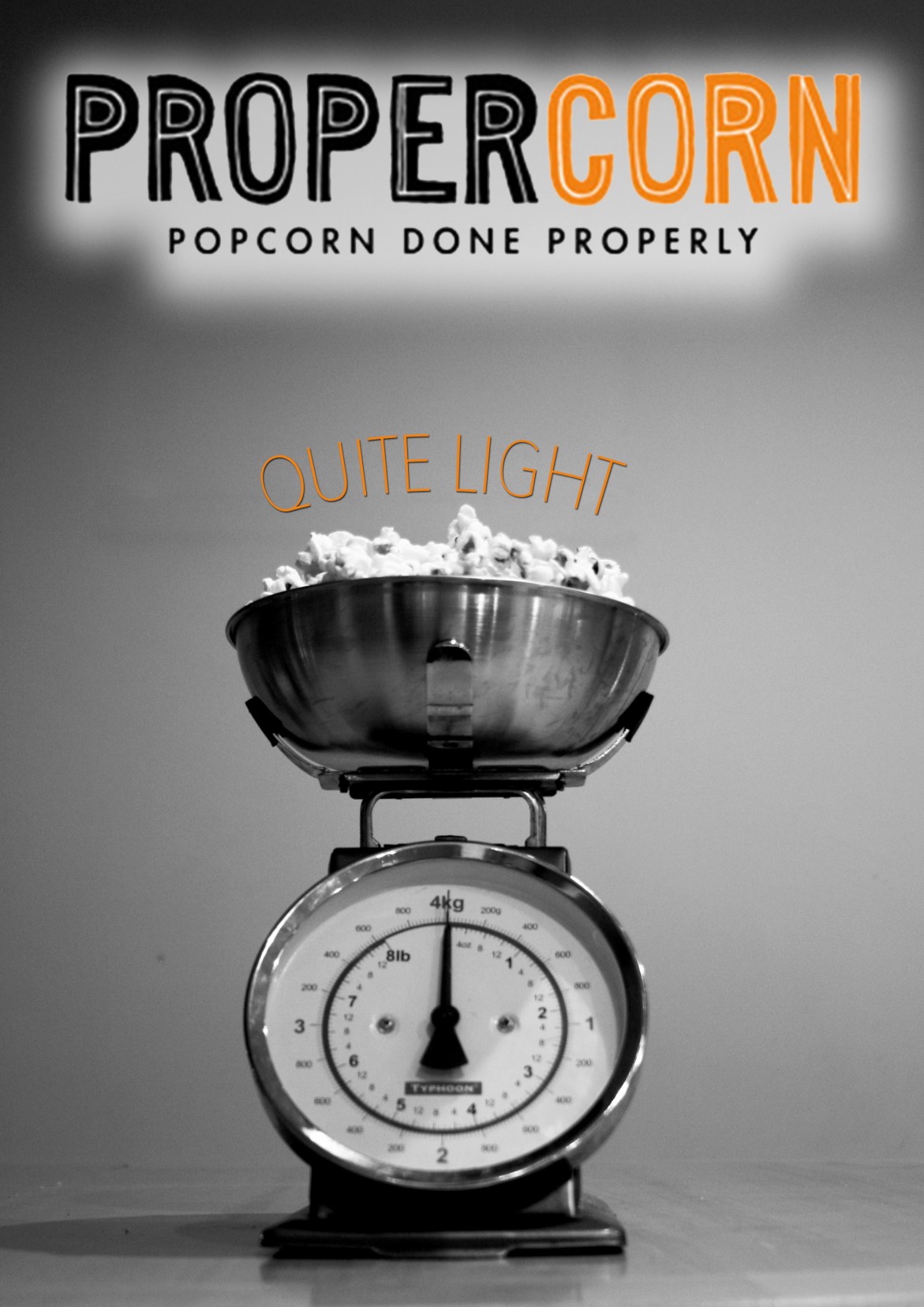 propercorn print ad of light popercorn in kitchen scales (b/w with orange)