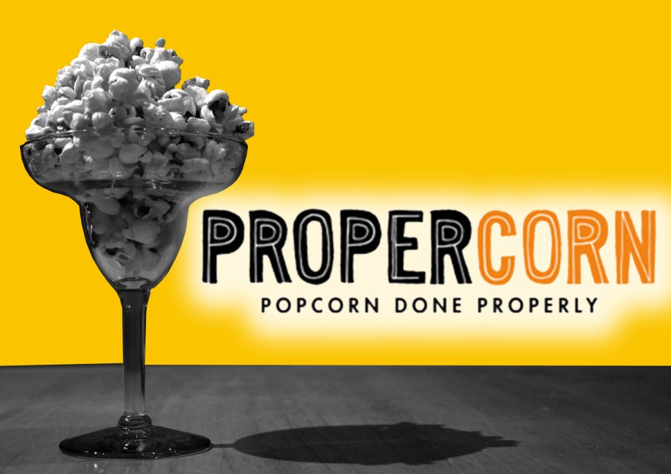 propercorn advertising - popcorn in cocktail glass b/w with light orange background